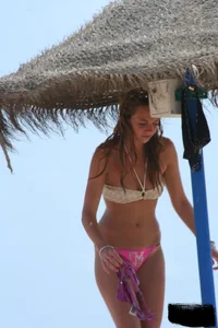 Hot beach girl undressing and going topless