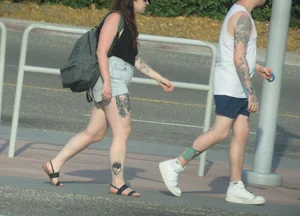 Brunette tattood babe in jean shorts giving a peek of her black panties