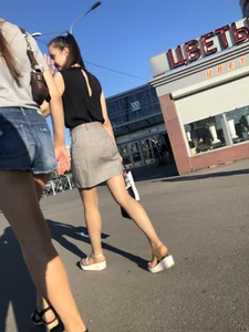 Two Hot Girls on a Street in Denim Shorts and a Skirt - One Touching Her Booty - Creepshots Gallery