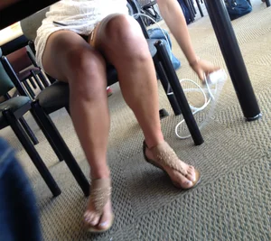 Sexy brunette upskirted showing her blue panties under the table