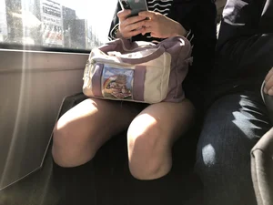 A Very Cute And Skinny Candid Teen Girl Wearing Glasses, A Skirt And Knee Socks Sitting in a Public Bus, Closeups of Her Legs
