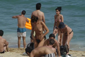 Topless girls on a beach in Barcelona