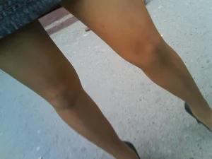 Milf in Pantyhose on High Heels in a Skirt on the City Street Legs Closeup Creepshot