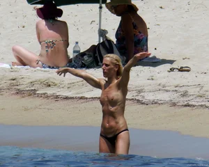 Small boobed topless milf on the beach