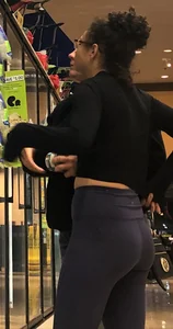 Girl with glasses shopping in leggings showing her VPL