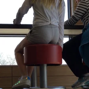 Gorgeous teen in shorts in a cafe