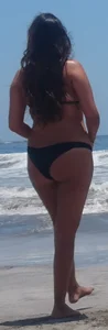 Thick brunette beach babe booty in a little black bikini