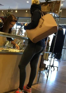 Brunette jewelry shopping in leggings with a nice ass