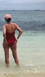 Milf at the beach in a red swimsuit with a nice body