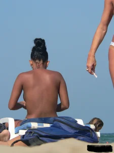 Hot ass topless beach girl with great tits lets her little brother oil up her ass in thong bikini