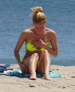 Sexy ass blonde milf on the beach in a thong with cameltoe and bending over