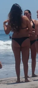 Thick brunette beach babe booty in a little black bikini
