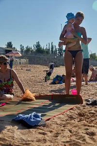 Sexy blonde milf on the beach in blue thong bikini and showing nice camel toe