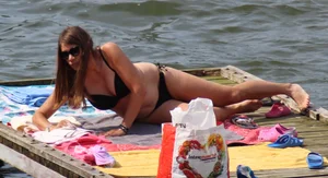 Thick babe with big boobs in a black bikini