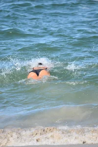 Thick mature brunette bikini lady on the beach with a nice body