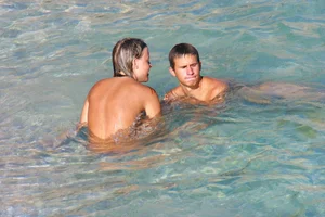 FKK Nudists playing in the water with floater