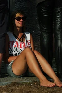 Three girls sitting, one redhead in jeans and a redhead and blonde in shorts