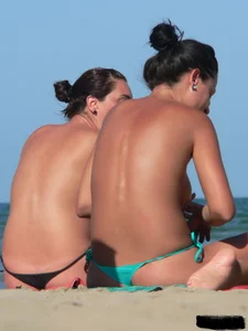 Bunch of sexy babes on the beach topless and in thong bikinis