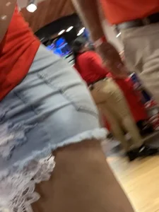 Bunch of girls in various outfits at a Cardinals baseball game