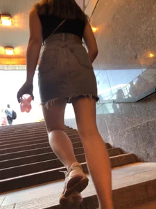 Hot chick wearing a fringed skirt walking up the stairs