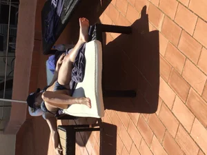 Blonde laying out in a blue bikini with a sexy body