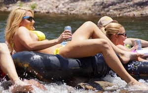 Sexy party girls in bikinis on a lake