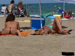 2 topless thonged sexy friends on the beach with great bodies