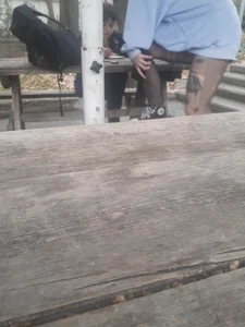 College teen in ripped pantyhose sitting outside