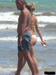 Sexy blonde on the beach in a yellow thong bikini