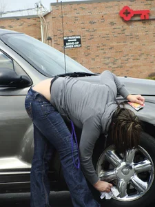 Girl cleaning her car in jeans and showing some cheetah print underwear