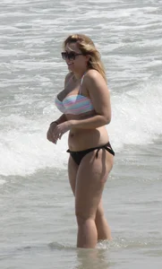 Big boobed thick blonde on the beach in a bikini