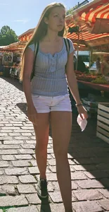 Pretty blonde babe with nice legs in white denim shorts