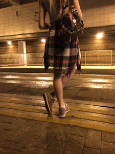 Cute Teen in Shorts on the Tram Stop