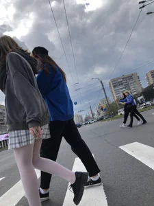 Candid teen girl wearing a skirt and white pantyhose crossing the street creepshots