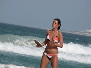 Skinny and sexy lady in a bikini playing on the beach
