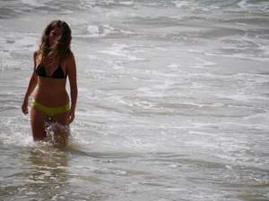 Sexy girl in yellow and black bikini on the beach