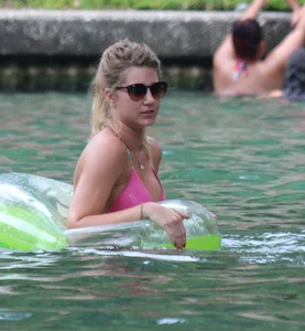 Blonde bikini girl at the pool in pink bikini top with amazing tits
