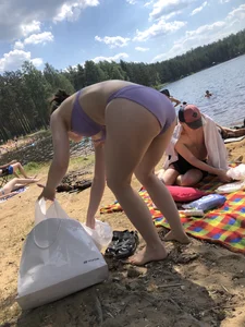 Chunky Candid Woman in a Purple Swimsuit Bending Over at the Beach Creepshot