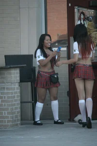 Two sexy Tilted Kilt employees showing cleavage and cheeks