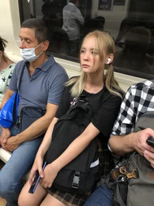 Skinny Teen in a Chequered Skirt With a Backpack in a Subway
