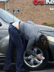 Girl cleaning her car in jeans and showing some cheetah print underwear