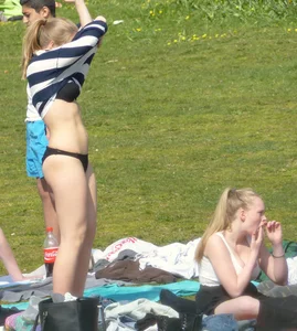 Teen taking off her dress in the park