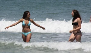 Brunette and redhead on the beach in bikinis looking sexy
