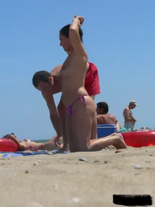 Purple thong topless lady on the beach gets oiled up by her husband
