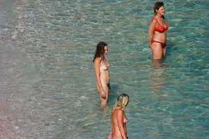FKK Nudists playing in the water with floater