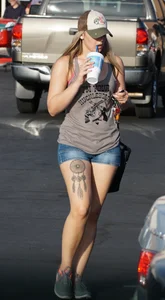 Hot blonde after shopping in short jean shorts and tank top