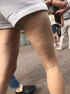 Hot Candid Girl in a Top, Shorts and Sneakers Skinny Legs Closeup Creepshots Gallery on the City Street