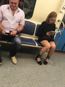 Girl in a Dress Reading a Book in Subway Train Candid