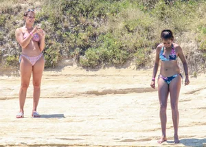 Group of sexy friends at the beach in bikinis