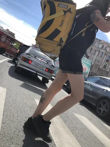 Amazing cute candid food delivery girl with lots of tattoos crossing the street